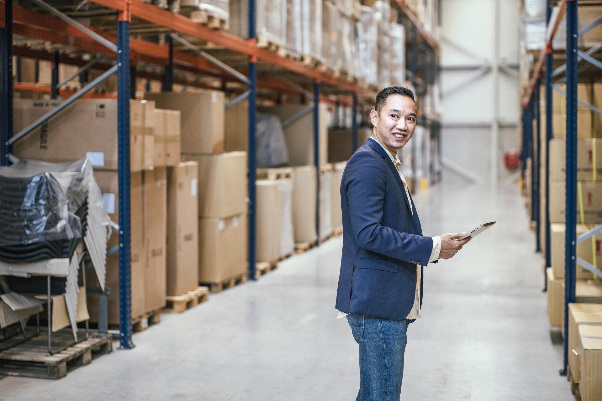 Man staat met tablet bij een stelling met producten